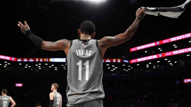 A Brooklyn Nets player is raising his arms during a game in an arena, HD Desktop Wallpaper