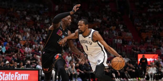 A Brooklyn Nets player drives the ball past a defender during a basketball game, HD Desktop Wallpaper