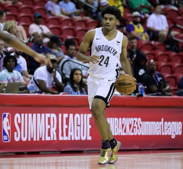 A Brooklyn Nets player is dribbling the basketball during a summer league game, HD Desktop Wallpaper
