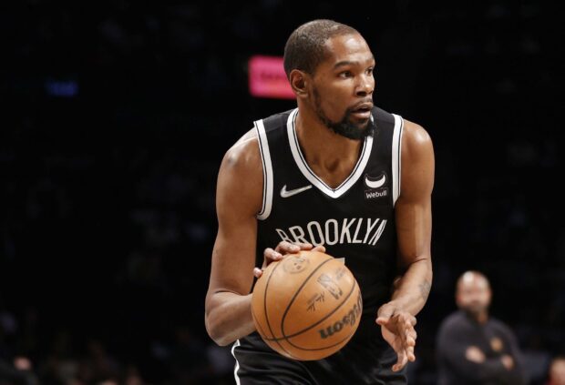 A Brooklyn Nets player is focused while dribbling the basketball during a game, HD Desktop Wallpaper