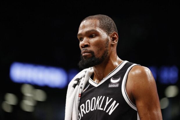 A Brooklyn Nets player is captured with a towel over his shoulder during a game, HD Desktop Wallpaper