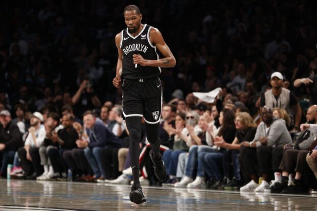 A Brooklyn Nets player runs on the basketball court during a game, HD Desktop Wallpaper