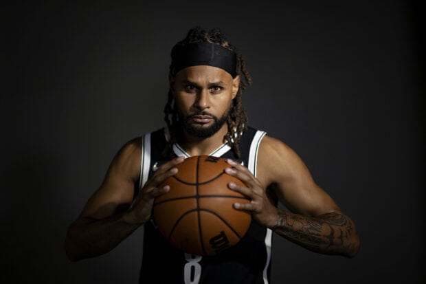 A Brooklyn Nets player holds a basketball with focus and intensity, 2K Desktop Wallpaper
