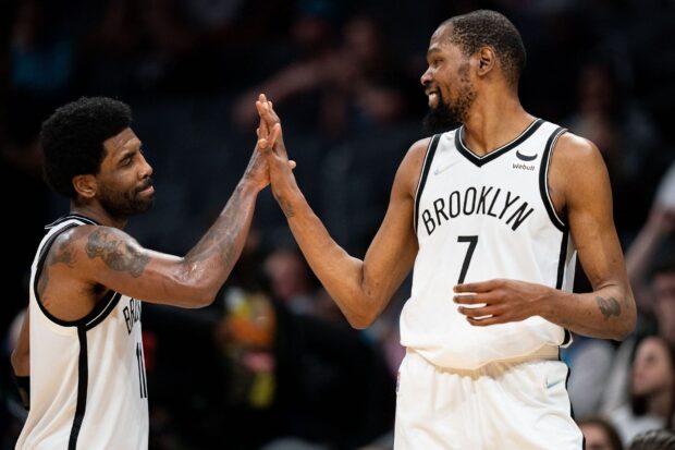 Two Brooklyn Nets players high five during game action, HD Desktop Wallpaper