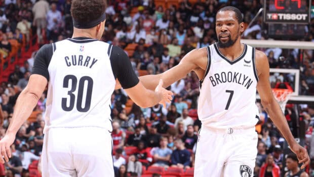 Two Brooklyn Nets players are celebrating during a basketball game in front of a crowd, HD Desktop Wallpaper