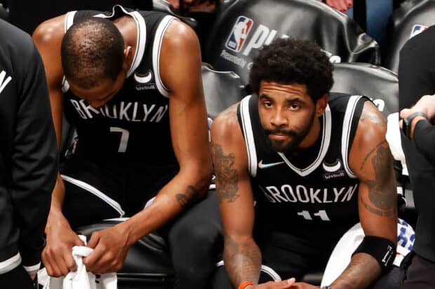 Two Brooklyn Nets players sit focused during a game timeout, HD Desktop Wallpaper