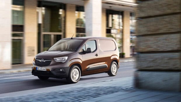 Brown Opel Combo driving fast on a city street near modern buildings, 4K Desktop Wallpaper