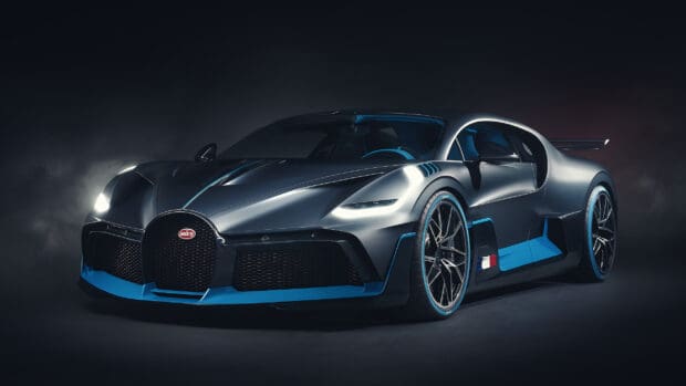 A sleek Bugatti Divo with blue accents illuminated against a dark background, 2K Desktop Wallpaper