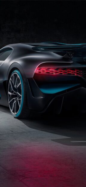 A Bugatti Divo shows its rear side with illuminated taillights and detailed rims, 2K Phone Wallpaper