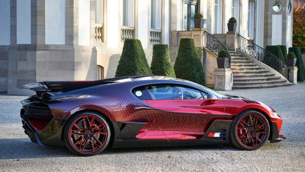 A red and black Bugatti Divo with distinctive patterns parked by a grand building, 4K Desktop Wallpaper