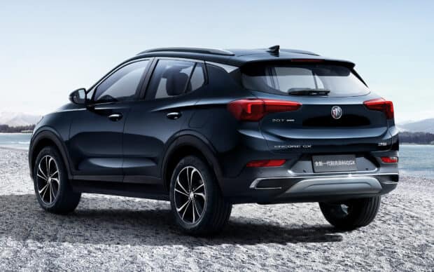 A black Buick Encore is parked near a lake with mountains in the background, HD Desktop Wallpaper