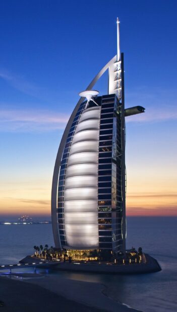 The Burj Al Arab is a famous luxury hotel in the United Arab Emirates at sunset, 2K Phone Wallpaper