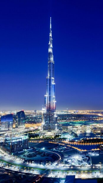 The United Arab Emirates Wallpapers features the illuminated Burj Khalifa tower in Dubai under a clear night sky, 2K Mobile Wallpaper