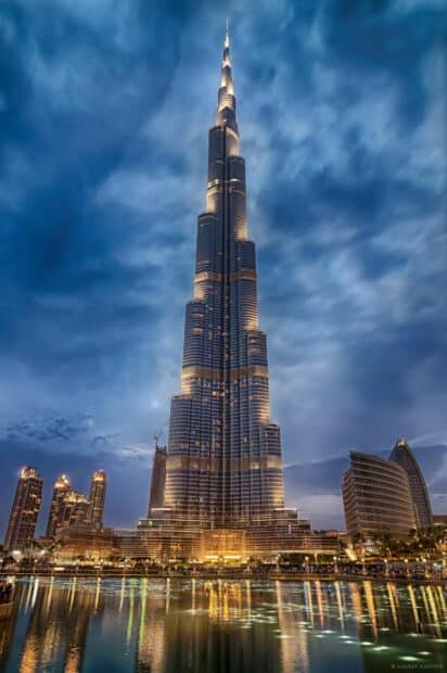 The Burj Khalifa shines brightly reflecting in the water with a cloudy sky, HD Desktop Wallpaper