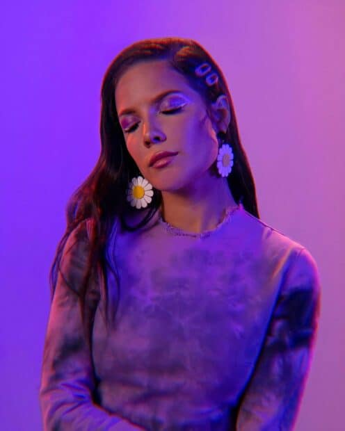 A serene portrait of Halsey with closed eyes and floral earrings in purple light, HD Phone Wallpaper