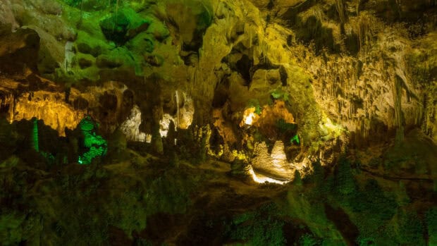 The Carlsbad Caverns National Park shows illuminated cave formations and pathways inside the cavern, HD Desktop Wallpaper