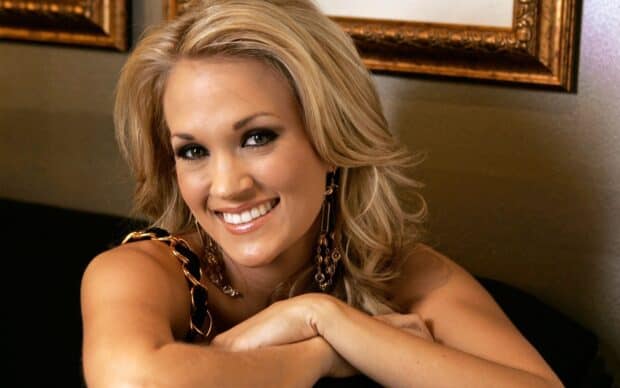 Carrie Underwood smiles warmly with her arms resting on a surface in this natural portrait, HD Desktop Wallpaper