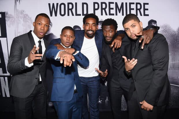 Five men dressed formally smiling and posing at the Straight Outta Compton premiere event, HD Desktop Wallpaper