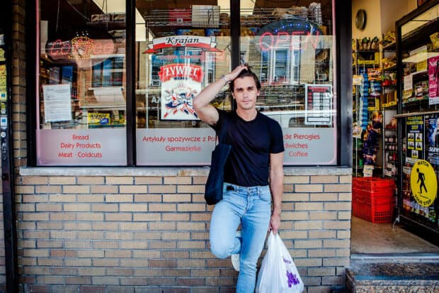 Antoni Porowski stands outside a store holding a shopping bag, HD Desktop Wallpaper