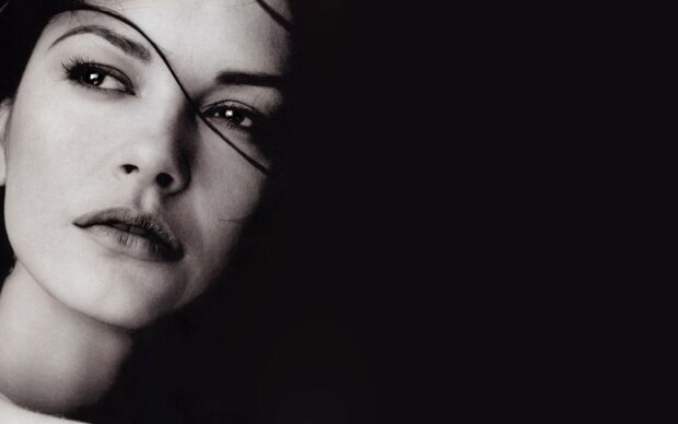 Catherine Zeta Jones looks thoughtful in a black and white close up portrait, HD Desktop Wallpaper