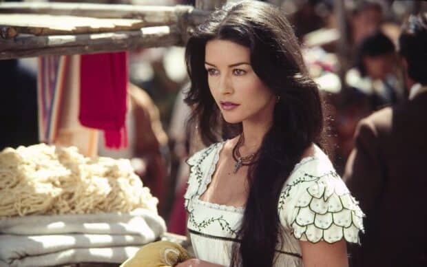 Catherine Zeta Jones wears a detailed white dress in an outdoor market setting, HD Desktop Wallpaper