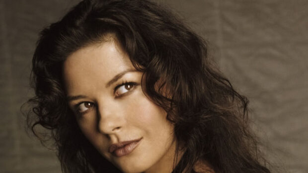 Catherine Zeta Jones looks thoughtfully to the side with curly hair in this portrait, HD Desktop Wallpaper
