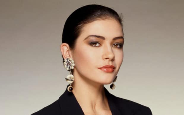 Catherine Zeta Jones looks confident and poised in a close up portrait wearing a black blazer and unique earrings, HD Desktop Wallpaper