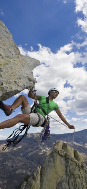 A man in green shirt rock climbing on a steep cliff with mountainous background, HD Phone Wallpaper