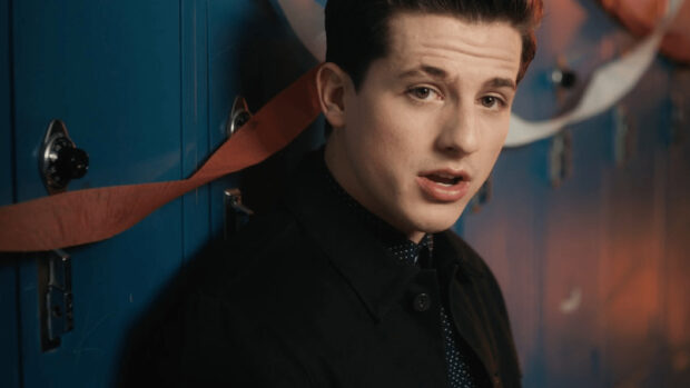 Charlie Puth close up portrait wearing black jacket by blue lockers, 2K Desktop Wallpaper