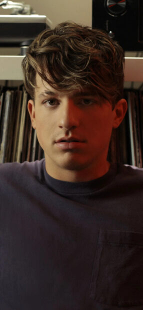 A close up portrait of Charlie Puth with a thoughtful expression, HD Phone Wallpaper
