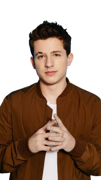 Charlie Puth poses wearing a brown jacket and white shirt with hands together, 4K Phone Wallpaper