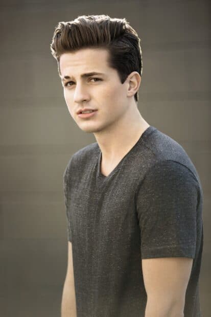 Charlie Puth is wearing a dark grey t shirt looking at the camera, 2K Mobile Wallpaper