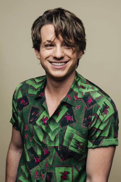 Charlie Puth smiling while wearing a green patterned shirt against a plain background, HD Mobile Wallpaper