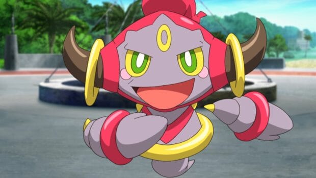 The cheerful Hoopa character is shown in an outdoor setting with greenery in the background, HD Desktop Wallpaper