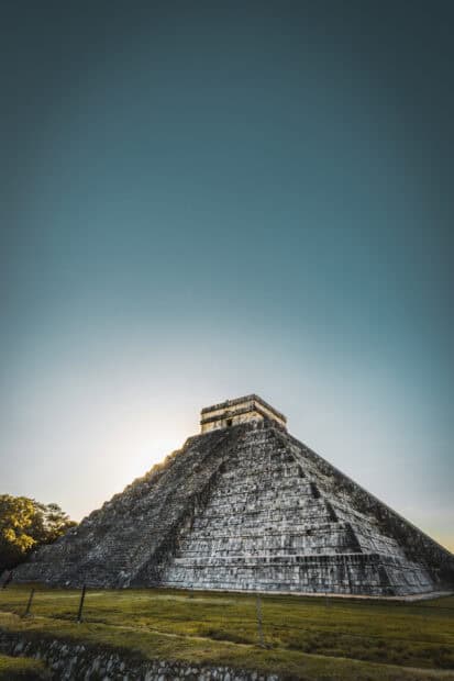 The Chichen Itza pyramid stands tall during sunset with a clear sky, 2K Mobile Wallpaper