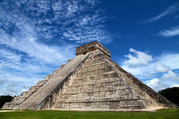 The Chichen Itza pyramid stands tall under a partly cloudy blue sky in Mexico, HD Desktop Wallpaper