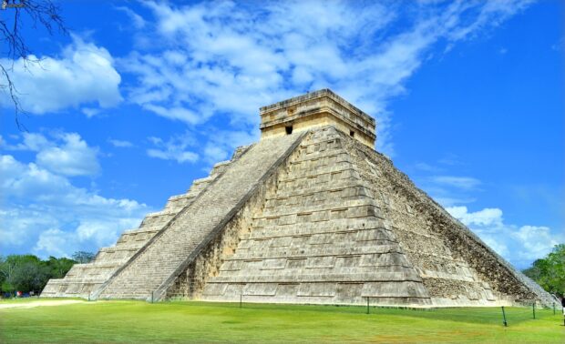 The Chichen Itza pyramid stands under a blue sky with scattered clouds, 2K Desktop Wallpaper