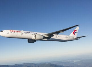 A China Eastern Airlines airplane flies over mountains with clear blue sky, 2K Desktop Wallpaper