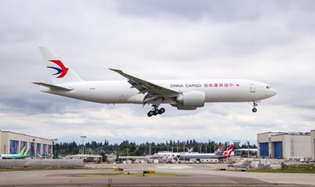 A China Eastern Airlines cargo plane is landing at the airport runway on a cloudy day, HD Desktop Wallpaper