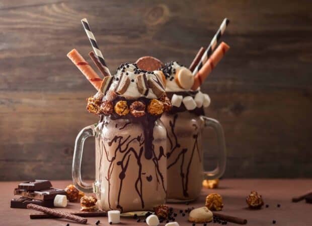 A chocolate milkshake with various toppings and straws served in glass mugs, 2K Desktop Wallpaper