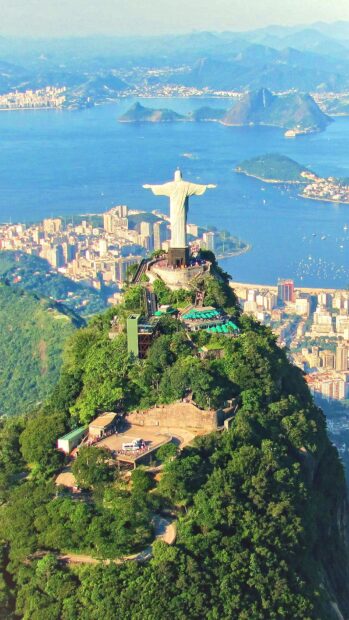 The Christ the Redeemer statue overlooks the city and bay in Rio De Janeiro with lush greenery, Rio De Janeiro Wallpapers, HD Mobile Wallpaper