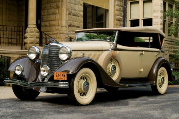 A classic Lincoln car with vintage design parked outside a stone building, HD Desktop Wallpaper