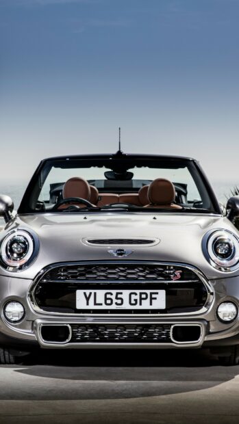 A silver Mini Cooper convertible is parked with a clear sky in the background, 2K Phone Wallpaper