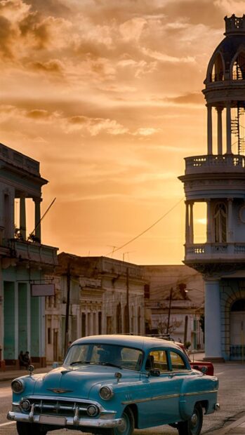 A classic blue car drives through the streets of Havana Cuba at sunset, HD Mobile Wallpaper