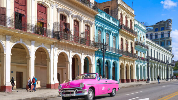 A pink vintage car drives past historic buildings in Havana Cuba with bright colors, HD Desktop Wallpaper