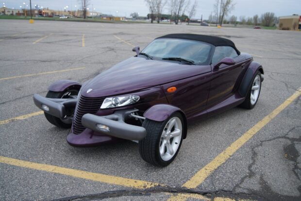 A purple Plymouth Prowler is parked in an empty lot on a cloudy day, 2K Desktop Wallpaper