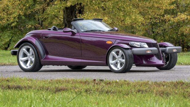 A purple Plymouth Prowler car parked on a road with trees in the background, 2K Desktop Wallpaper
