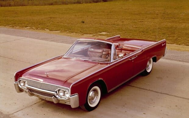 A classic red Lincoln car shows off its vintage design and leather interior on a driveway, HD Desktop Wallpaper