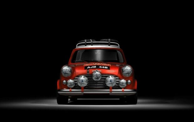 A classic red Mini Cooper with rally lights and spare tires on roof, HD Desktop Wallpaper