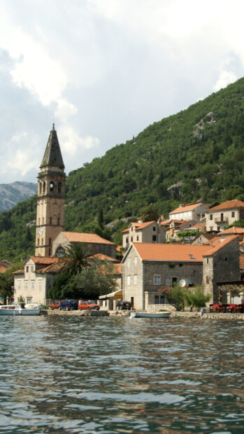 A coastal town in Montenegro with historic buildings and green hills by the water, HD Phone Wallpaper